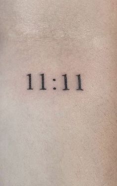 a tattoo with the word 11 11 on it's left side ribcage