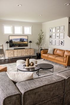 a living room filled with furniture and a flat screen tv mounted to the side of a wall