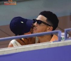 a man and woman kissing in the stands