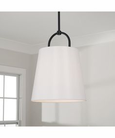 a white lamp hanging from the ceiling in a room