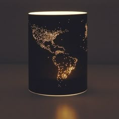 a lit up coffee cup with the world map on it