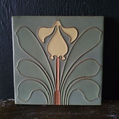 a decorative tile with a flower on it