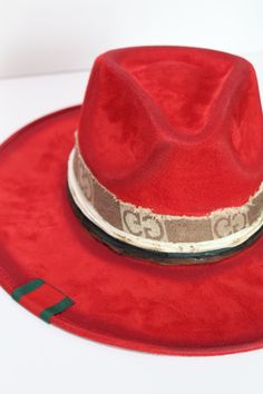 Our love of hats continues with this incredible handmade original: meet the Luxe Banded Hat in red. A hat this good needs to be worn as much as possible and with every single outfit! Hand made by artisans, incredible quality, pure suede, genuine leather trim around the crown, iconic trim, the list goes on! Will ship 12/1. The best part? It's super structured with an elastic band on the inside that will fit EVERYONE. Btw never taking this hat off. These hats are a limited edition. THE HAT:-Rancher style hat, pure suede-Stiff brim with elastic hat band on the inside-- OMG YES-Classic, standout red-Genuine leather trim and chain-- talk about luxe-Incredible quality-Holds it's shape amazingly 22.5 inches 3.5 inch brim // 4 inch crown100% suede Red Adjustable Flat Brim Fedora, Red Fedora With Flat Brim, Red Adjustable Fedora With Curved Brim, Red Adjustable Felt Hat With Curved Brim, Adjustable Red Felt Hat With Curved Brim, Red Curved Brim Felt Hat For Festivals, Red Felt Hat With Curved Brim For Festivals, Adjustable Red Fedora Hat Band, Red Adjustable Fedora Hat