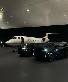 a black car parked in front of a private jet