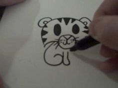 someone is drawing a tiger face on paper