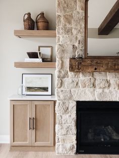 a stone fireplace with wooden shelves above it