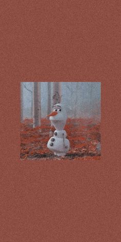 a snowman is standing in the middle of an area with red grass and trees