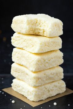 a stack of shortbreads sitting on top of a piece of paper next to some white sugar