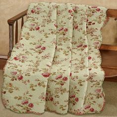 a crib bed with a floral quilt on it