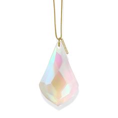 a white necklace with a gold chain hanging from it's center, and a large faceted crystal stone in the middle