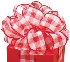 a red and white checkered bow on top of a present box with the words happy birthday