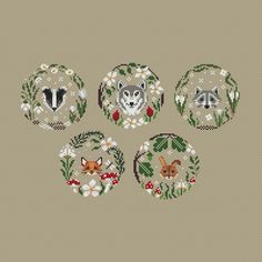 four cross stitch designs with different animals in the center and flowers on each one side