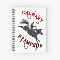 a spiral notebook with an image of a cowboy riding a horse and the words calgary stampede