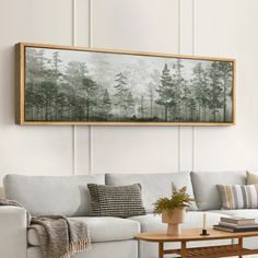 a living room with a couch, coffee table and painting on the wall above it