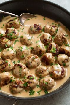 a skillet filled with meatballs covered in gravy