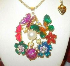 LOVELY MULTI COLOR CRYSTAL PEARL AND CRYSTALS WITH ENAMEL FINISH ARRAY OF BUTTERFLIES, LADYBUG AND FLOWERS FASHION PENDANT NECKLACE DESIGN BY BETSEY JOHNSON.  IT HAS A YELLOW GOLD PLATED CHAIN MEASURING 30 INCHES IN LENGTH WITH A LOBSTER CLAW CLASP CLOSURE AND BJ LOGO CHARM IN PLACE.  THE PENDANT MEASURES APPROXIMATELY 1.8 INCHES IN HEIGHT AND 2.1 INCHES IN WIDTH.  BEAUTIFUL, MAKES A GREAT GIFT OR ADDITION TO A COLLECTION.  SEE MY PHOTOS FOR THE BEST DESCRIPTION OF THIS PIECE.  KEEP IN MIND THAT Flower Butterfly Charm Jewelry Gift, Flower Shaped Butterfly Charm Jewelry As Gift, Flower Shaped Butterfly Charm Jewelry Gift, Flower-shaped Butterfly Charm Jewelry Gift, Spring Butterfly Charm Jewelry Gift, Multicolor Butterfly Charm Necklaces, Multicolor Flower Pendant Necklace, Whimsical Multicolor Flower Shaped Jewelry, Multicolor Flower Pendant Jewelry With Charm