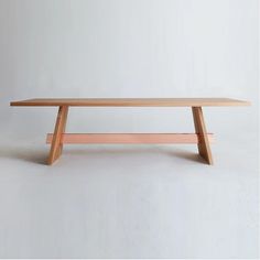 a wooden bench sitting on top of a white floor