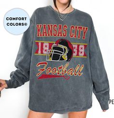 The perfect, comfortable sweatshirt to cheer on your favorite Kansas City Football team! Luxurious comfort and style are what this unisex, garment-dyed sweatshirt is all about. It's made with 80% ring-spun cotton and 20% polyester and the fabric is 3-end garment-dyed, ring-spun, color-blast fleece with a 100% cotton face. Each sweatshirt comes with a relaxed fit, a rolled-forward shoulder, and a back neck patch.  .: 80% ring-spun cotton, 20% polyester .: Medium-heavy fabric (9.5 oz /yd² (322.1 g Retro Oversized Tops For Game Day, Oversized Retro Top For Game Day, Retro Game Day Tops For Fall, Retro Tops For Game Day In Fall, Retro Fall Tops For Game Day, School Spirit Long Sleeve Sweatshirt With Graphic Print, School Spirit Graphic Print Sweatshirt With Relaxed Fit, School Spirit Graphic Print Long Sleeve Sweatshirt, Collegiate Soft-washed Tops For Streetwear