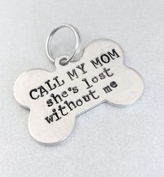 a dog tag that says, call my mom she's lost without me