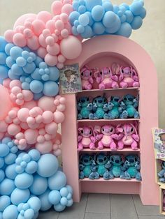 there is a pink and blue display with balloons