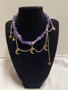 Estela is our amethyst, gold, and moon charm necklace.  ~It is made with a variety of star and moon charms. The necklace is made of gold chains and is brought together by a lobster clasp.  ~This necklace has extra chain so size adjustments can be made if needed.  ~Please choose either the sun or moon as the middle charm.  ~All of our necklaces are handmade Product Care:  -Apply beauty products such as perfume, hairspray or deodorant before wearing your jewelry as certain chemicals in these products may damage the finish. -Always remove your jewelry before swimming, bathing, doing household chores or using abrasive cleaners  If you have any questions let us know and we will be happy to answer them. Have a nice day! Adjustable Purple Moon Phase Jewelry, Celestial Amethyst Moon Charm Jewelry, Celestial Amethyst Jewelry With Moon Charm, Adjustable Celestial Crystal Necklaces With Moon Charm, Adjustable Celestial Crystal Necklace With Moon Charm, Purple Bohemian Jewelry With Moon Charm, Handmade Celestial Amethyst Necklace, Bohemian Purple Jewelry With Moon Charm, Adjustable Purple Celestial Jewelry