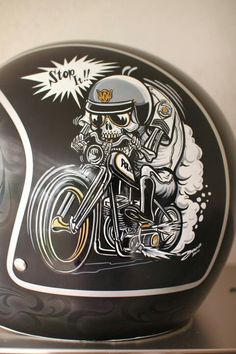 a motorcycle helmet with a skull riding on it's side and the words stop