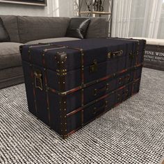 a large suitcase sitting on top of a rug in front of a couch