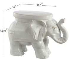 an elephant shaped white ceramic container with its trunk curled up to it's side