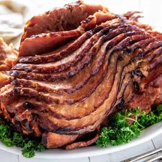 sliced ham on a white plate with parsley