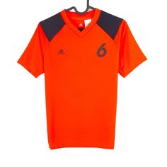 an orange soccer jersey with the number 6 on it, hanging from a hanger