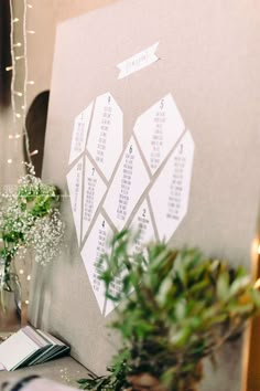 the table is set up with flowers and greenery for guests to sign their names