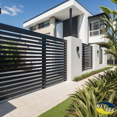 a modern house with black and white fence