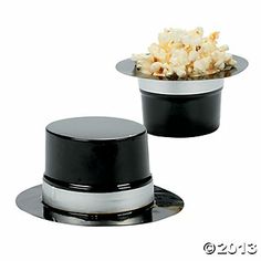 two black and white bowls with popcorn in them sitting on top of eachother