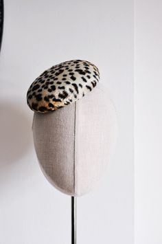 Mini Leopard. The Classics Collection.  A perfectly simple statement headpiece ideal for everyday wear, as well as special occasions. This new size has been hand blocked from thermoplastic and leopard print faux ponyskin short pile fur  using traditional millinery techniques involving steam and wooden hat blocks. Lined, and finished with a wired brim edge to maintain sturdiness, and a hot pink petersham ribbon sweatband. Measures approx 5" - 13.5cm in diameter. Held in place with a fine black me Wedding Dress Buttons, Mini Hats, Large Brim Hat, Hat Blocks, Hat Fascinator, Types Of Hats, Cocktail Hat, Pillbox Hat, Pill Boxes