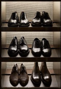 several rows of men's dress shoes on shelves