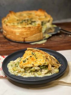 a plate that has some kind of food on it with a pie in the background