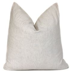 a white and grey striped pillow on a white background