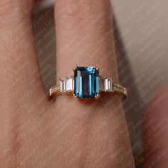 Emerald-cut Sapphire Ring With Topaz Accent Stones, 14k Gold Emerald Cut Topaz Ring, Blue Topaz Baguette Cut Ring In 14k Gold, Blue Emerald-cut Topaz Ring In 14k Gold, Blue Emerald Cut Topaz Ring In 14k Gold, Blue Topaz Baguette Cut Ring, Baguette Cut Blue Topaz Ring, Topaz Ring Yellow, Sapphire Engagement Ring Emerald Cut