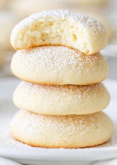 three sugar cookies stacked on top of each other with powdered sugar in the middle