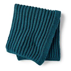 a blue knitted scarf on a white background