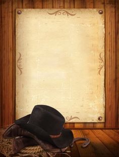 a cowboy hat sitting on top of a pile of hay next to an old paper