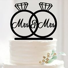 a wedding cake topper with two rings and the words mr and mrs on it