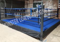 an empty boxing ring in the middle of a warehouse