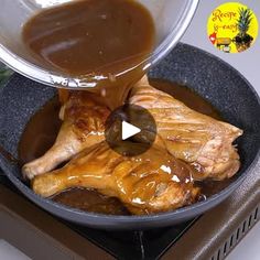 a person pouring sauce on a chicken in a pan