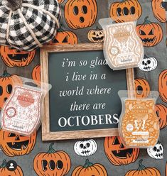 some pumpkins are sitting on a table with a chalkboard and magnets in front of them