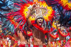 a group of people in colorful costumes and headdress