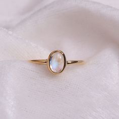 "Materials Gold, Rose gold, White gold Moonstone Ring / Oval Cut Moonstone Ring In 14k Gold / Stackable Moonstone Ring / Natural Moonstone / June Birthstone Ring / Gemstone Ring Item Features * Made to Order. * Gold KT: 14K solid gold * Custom Gold Color: Rose Gold, Yellow Gold, White Gold * Gemstone Cut: Oval * Number of Stones: 1 * Stone Size: 6x4 mm * Setting Type: Bezel * Band Width: 1.25mm * Ring is marked gold Marked * ready to Ship in 7-10 Business Days * Also available in other gemstone Bezel Band, Gold Moonstone Ring, June Birthstone Ring, Peridot Ring, June Birthstone, Solid Gold Rings, Ring Oval, 14k Gold Ring, Ring Gemstone