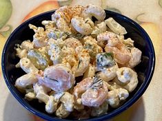 a blue bowl filled with food on top of a table