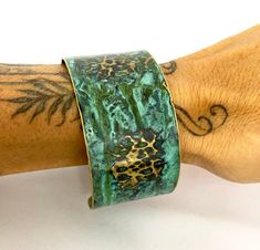 These unique, hand-formed copper and brass cuff bracelets with vibrant patinas create stunning accents to your personal style. Dress up or down- either way you'll be wearing an adornment that will turn heads, start conversations, and delight the eye of the beholder. This is a hammered Brass cuff with gorgeous marbled green/blue patina. Please note that patina colors will look different depending on the screen/device you view them on. This is a medium cuff- see measurements below. Cuffs have a 1” Adjustable Green Cuff Bracelet With Patina, Adjustable Patina Cuff Bracelet, Adjustable Patina Cuff Bracelet Wearable Art, Bronze Wearable Art Cuff Bracelet As Gift, Green Patina Cuff Bracelet As Gift, Green Patina Cuff Bracelet Gift, Brass Cuff Bracelet With Patina As A Gift, Artistic Adjustable Patina Cuff Bracelet, Copper Cuff Bracelet With Patina As Gift