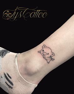 a small pig tattoo on the ankle